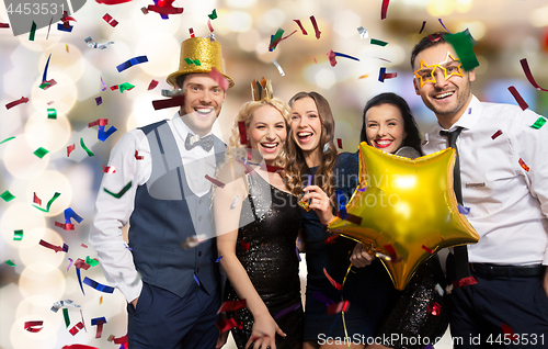 Image of friends with party props and confetti laughing