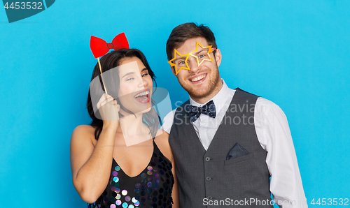 Image of happy couple with party props having fun