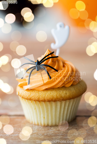 Image of cupcake with halloween decoration on table