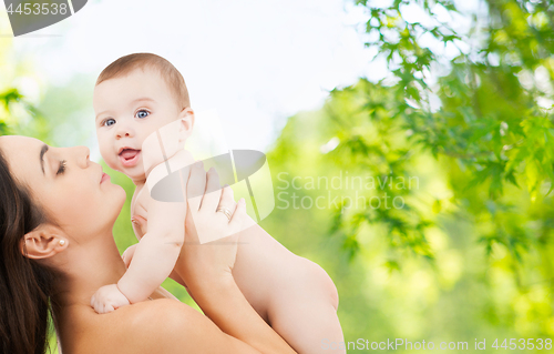 Image of mother with baby over green natural background