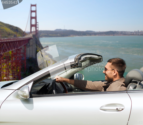 Image of man driving car over golden gate bridge