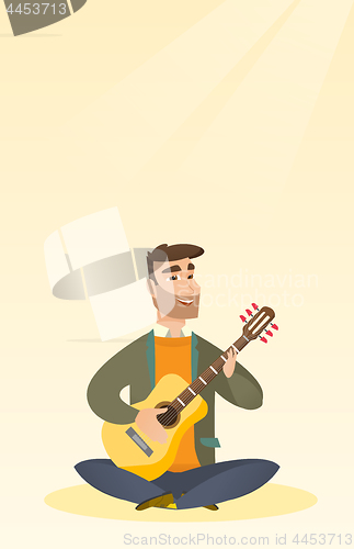 Image of Man playing the acoustic guitar.