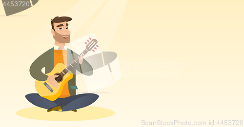 Image of Man playing the acoustic guitar.