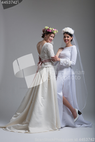 Image of Portrait of two beautiful young bride in wedding dresses