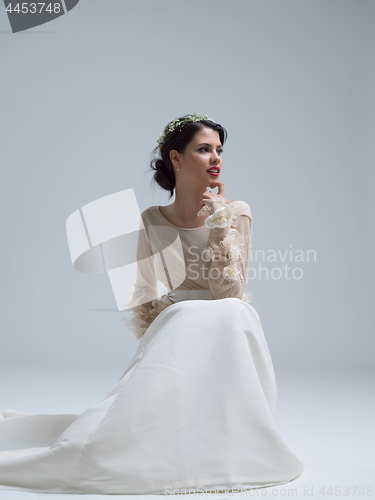 Image of young bride sitting in a wedding dress