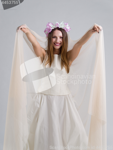 Image of young bride in a wedding dress with a veil