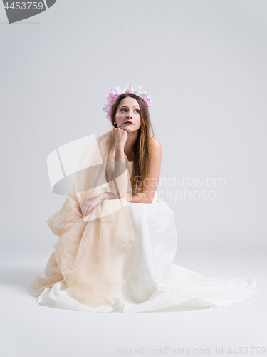 Image of young bride sitting in a wedding dress