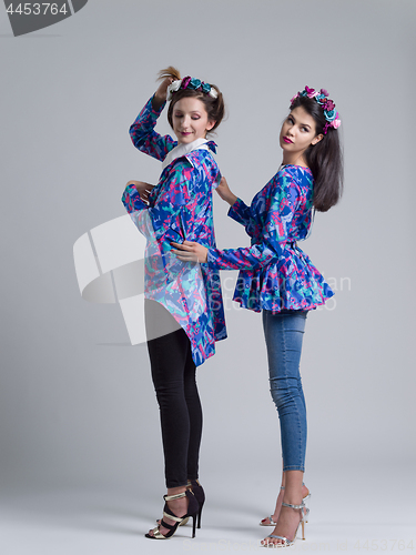 Image of two Fashion Model girls isolated over white background