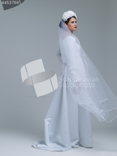 Image of young bride in a wedding dress with a veil