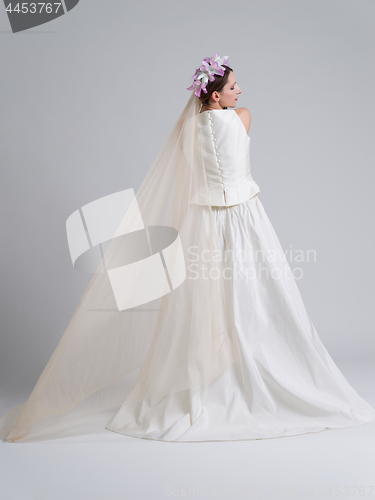 Image of Rear view of a beautiful young woman in a wedding dress