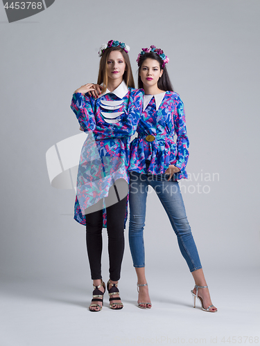 Image of two Fashion Model girls isolated over white background