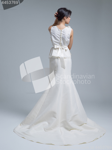 Image of Rear view of a beautiful young woman in a wedding dress