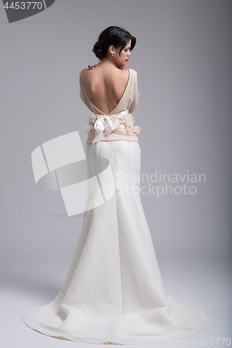 Image of Rear view of a beautiful young woman in a wedding dress