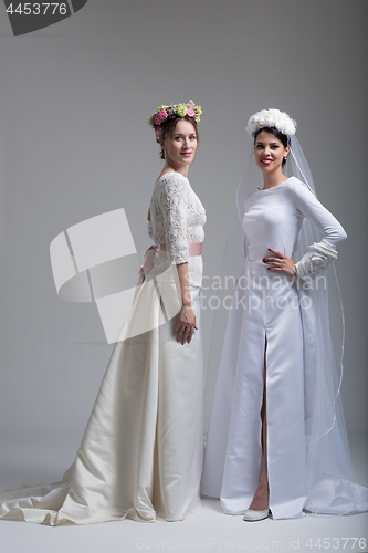 Image of Portrait of two beautiful young bride in wedding dresses