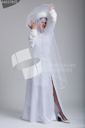 Image of young bride in a wedding dress with a veil