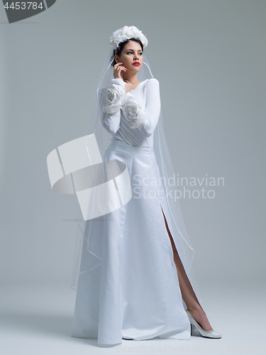 Image of young bride in a wedding dress with a veil