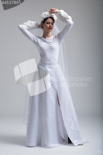 Image of young bride in a wedding dress with a veil