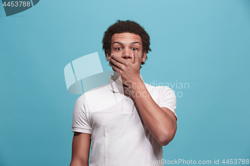 Image of The young attractive man looking suprised isolated on pink