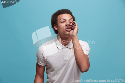 Image of Isolated on blue young casual man shouting at studio