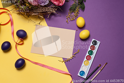 Image of Easter card. Painted Easter eggs in nest on yellow background