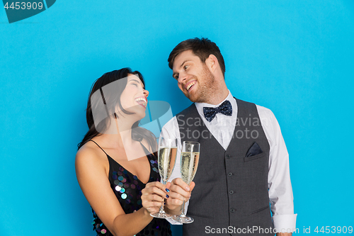 Image of happy couple with champagne glasses at party