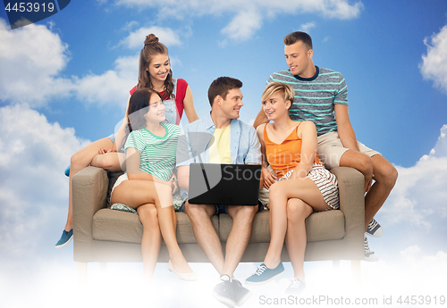 Image of friends with laptop computer sitting on sofa