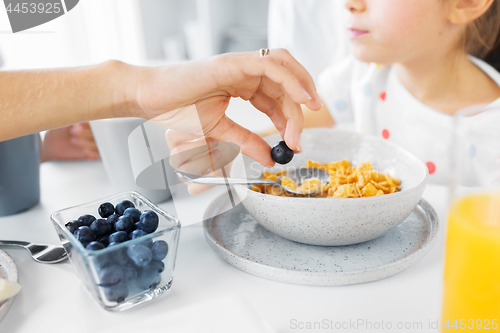 Image of close up of family having cereals for breakfast