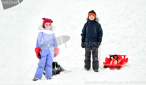 Image of happy little kids with sleds in winter