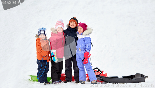 Image of happy little kids with sleds hugging in winter