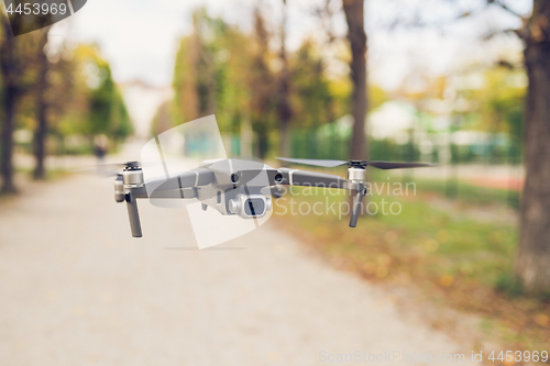 Image of Drone flying in the air in the park alley