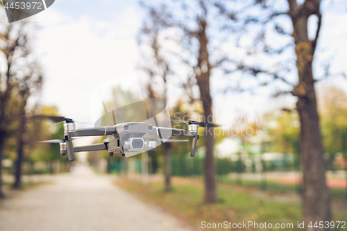 Image of Drone flying in the air in the park alley