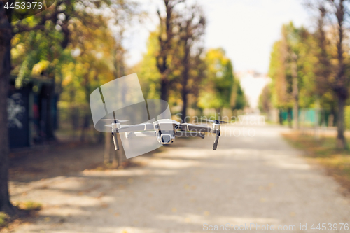 Image of Drone flying in the air in the park alley