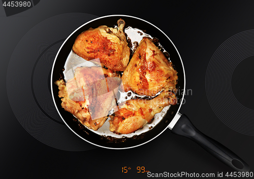 Image of chicken thighs on frying pan