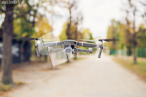 Image of Drone flying in the air in the park alley