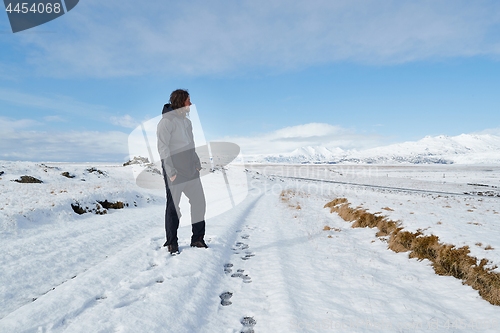 Image of Man standing on snowy landscpe