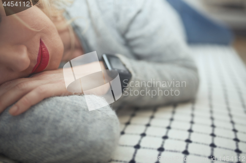 Image of Woman sleeping with smart watch