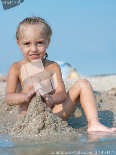 Image of Little girl on sandy beach