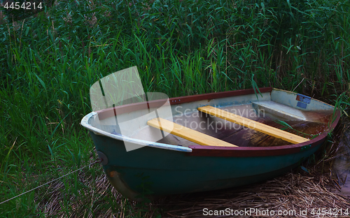 Image of Old Metal Rowing Boat Among The Reeds In The Twilight