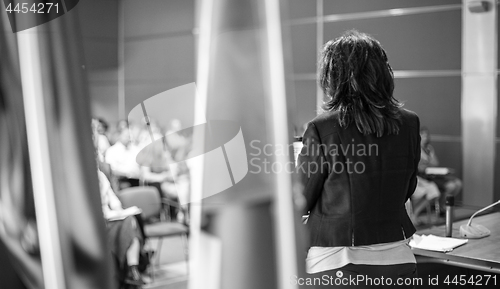 Image of Public speaker giving talk at Business Event.