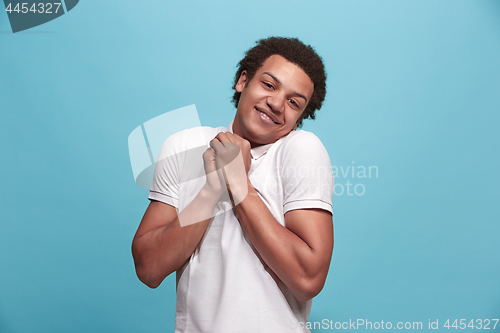 Image of Handsome man looking suprised isolated on blue