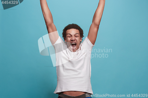 Image of Winning success man happy ecstatic celebrating being a winner. Dynamic energetic image of male model