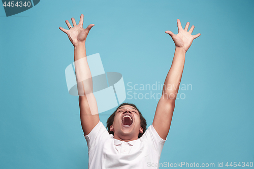 Image of Winning success man happy ecstatic celebrating being a winner. Dynamic energetic image of male model