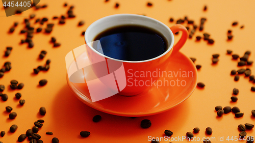 Image of Cup of coffee surrounded by beans