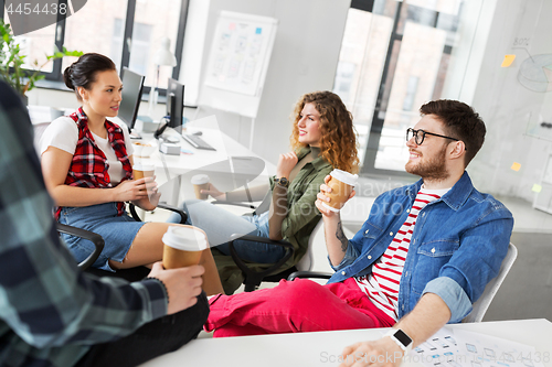 Image of creative team drinking coffee at office