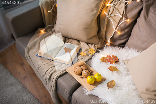 Image of lemons, book, almond and oatmeal cookies on sofa