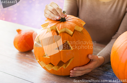 Image of close up of woman with halloween pumpkin