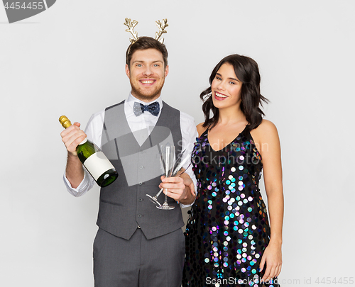 Image of couple with champagne bottle at christmas party