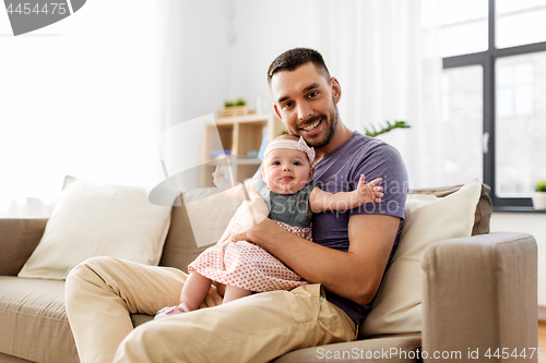 Image of father with little baby girl at home