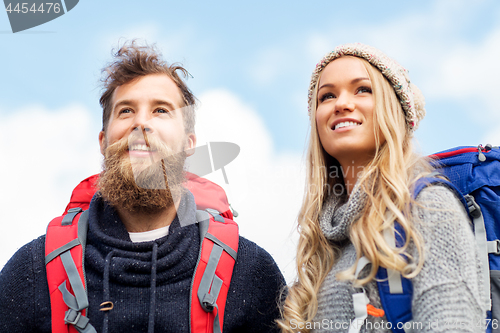 Image of couple of travelers with backpacks hiking
