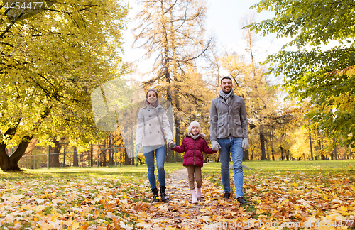 Image of happy family walking at autumn park